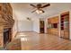Open concept living room featuring brick fireplace, hardwood floors, and built-in cabinetry at 342 Lakeshore Dr, Stockbridge, GA 30281