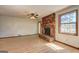 Bright living room showcasing a brick fireplace, large window, and hardwood floors at 342 Lakeshore Dr, Stockbridge, GA 30281