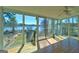 Sunroom with walls of windows offers panoramic views of the lake and direct access to the deck at 342 Lakeshore Dr, Stockbridge, GA 30281