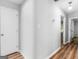 Hallway with hardwood floors and neutral walls with doors to adjacent rooms at 3500 Stonewall Se Pl, Atlanta, GA 30339