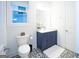 Charming bathroom with blue vanity, patterned tile floor, and ample natural light at 170 Fowler St # 200, Woodstock, GA 30188