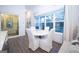 Bright dining area with marble table, white chairs, and large windows providing ample natural light at 170 Fowler St # 200, Woodstock, GA 30188