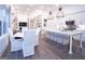Open-concept kitchen features stainless steel appliances, island with seating, and a seamless view into the living area at 170 Fowler St # 200, Woodstock, GA 30188