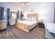 Spacious main bedroom features wood floors, large windows, and a calming color palette at 170 Fowler St # 200, Woodstock, GA 30188