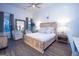 Spacious main bedroom features wood floors, large windows, and a calming color palette at 170 Fowler St # 200, Woodstock, GA 30188