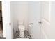 Elegant powder room with a classic toilet, pattern tiles, and great white trim at 170 Fowler St # 200, Woodstock, GA 30188