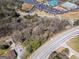 An aerial view of the wooded lot near commercial buildings and a business, ideal for development at 2218 Young Rd, Stone Mountain, GA 30088