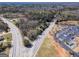 An aerial view of a wooded area with nearby businesses and a church in close proximity at 2218 Young Rd, Stone Mountain, GA 30088