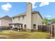 Backyard view with a pergola, lawn, and fenced perimeter at 312 Maddi Grace Ct, Locust Grove, GA 30248