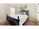 Bedroom with neutral walls, plush carpet, and a black wood bed at 312 Maddi Grace Ct, Locust Grove, GA 30248