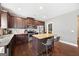 Kitchen features dark cabinets, granite countertops, and stainless appliances at 312 Maddi Grace Ct, Locust Grove, GA 30248
