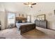 Bedroom features a large bed, ceiling fan, and large windows at 312 Maddi Grace Ct, Locust Grove, GA 30248