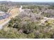 A scenic aerial shot shows the property nestled amongst lush trees, near commercial areas and major highways at 1849 Panola Rd, Stone Mountain, GA 30088