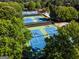 Aerial view of community tennis courts surrounded by lush greenery at 7085 Wakehurst Pl, Cumming, GA 30040