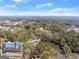 Stunning aerial view of a home and lake surrounded by trees on a spacious lot in a beautiful neighborhood at 897 Winding Trl, Lawrenceville, GA 30046