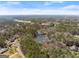 Peaceful aerial view of a lush neighborhood with a serene lake surrounded by mature trees and well-kept homes at 897 Winding Trl, Lawrenceville, GA 30046