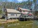 Waterfront home featuring a spacious deck with a grill, perfect for outdoor entertaining and relaxing at 897 Winding Trl, Lawrenceville, GA 30046