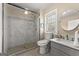 Modern bathroom featuring a glass shower and vanity with framed mirror at 897 Winding Trl, Lawrenceville, GA 30046