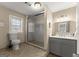 Neutral bathroom with a glass shower, light grey vanity with granite countertop, and a large window at 897 Winding Trl, Lawrenceville, GA 30046