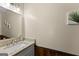 Half bath featuring granite counters, tiled backsplash, and decorative wall art at 897 Winding Trl, Lawrenceville, GA 30046