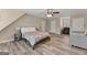 Spacious bedroom featuring wood-look flooring, ceiling fan, and sitting area at 897 Winding Trl, Lawrenceville, GA 30046