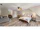 Bedroom features a daybed and ceiling fan with wood-look flooring at 897 Winding Trl, Lawrenceville, GA 30046