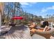 Wide plank deck with comfortable seating and an umbrella overlooking the lake at 897 Winding Trl, Lawrenceville, GA 30046