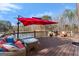 Wide plank deck with comfortable seating, red umbrella, and serene lake views at 897 Winding Trl, Lawrenceville, GA 30046