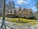 Exterior showcasing the side of the house, greenery, and staircase at 897 Winding Trl, Lawrenceville, GA 30046