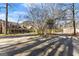 Exterior view showcasing the home, gravel driveway, and detached garage at 897 Winding Trl, Lawrenceville, GA 30046