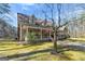 Exterior view revealing the side elevation, screened porch, and surrounding greenery at 897 Winding Trl, Lawrenceville, GA 30046