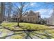 Exterior showcasing the side of the house, greenery, and staircase at 897 Winding Trl, Lawrenceville, GA 30046