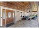Spacious front porch featuring stone flooring, wood ceiling and outdoor seating at 897 Winding Trl, Lawrenceville, GA 30046