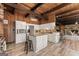 A gorgeous kitchen features white cabinets, granite counters, stainless appliances, and an island with an eat-in bar at 897 Winding Trl, Lawrenceville, GA 30046