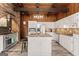 This great kitchen features stainless appliances, white cabinets, granite counters, and an island with an eat-in bar at 897 Winding Trl, Lawrenceville, GA 30046