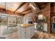 This rustic kitchen includes stainless appliances, white cabinets, granite counters, and an island with an eat-in bar at 897 Winding Trl, Lawrenceville, GA 30046