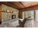 Cozy living room with a stone fireplace, hardwood floors, and sliding glass doors to the outdoor at 897 Winding Trl, Lawrenceville, GA 30046