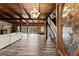 Bright living room featuring wood paneled walls and ceilings, hardwood floors, and glass doors at 897 Winding Trl, Lawrenceville, GA 30046