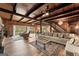 Open living room with exposed wood beam ceiling, stone fireplace, and walls of windows providing natural light at 897 Winding Trl, Lawrenceville, GA 30046