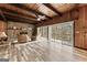 Relaxing living room featuring a stone fireplace, hardwood floors, glass doors and wood paneled walls at 897 Winding Trl, Lawrenceville, GA 30046