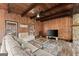 Comfortable living room offers wood paneled walls, neutral colored furniture, and plenty of natural light at 897 Winding Trl, Lawrenceville, GA 30046