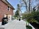 Back patio area with landscaping features including shrubs, patio, planters, and other decorative yard elements at 398 Lockridge Ln, Lawrenceville, GA 30046