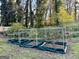 Backyard raised garden featuring a netting enclosure and bordering at 398 Lockridge Ln, Lawrenceville, GA 30046