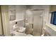 Bathroom featuring glass shower door, sink, and commode at 398 Lockridge Ln, Lawrenceville, GA 30046