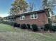 Brick house with trimmed bushes along the side, complemented by shuttered windows and a well-manicured lawn at 398 Lockridge Ln, Lawrenceville, GA 30046