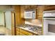 Kitchen featuring stainless appliances, wood cabinets, and granite countertops offers both functionality and style at 398 Lockridge Ln, Lawrenceville, GA 30046