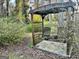 Secluded porch swing in backyard among the trees and landscaping creates a relaxing retreat to enjoy the outdoors at 398 Lockridge Ln, Lawrenceville, GA 30046