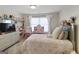 Well-lit bedroom featuring a comfortable bed and a vanity with a round mirror at 830 Turner Rd, Mcdonough, GA 30252