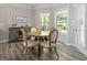 Cozy breakfast nook with round table near windows letting in natural light and a decorative cabinet at 830 Turner Rd, Mcdonough, GA 30252