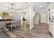 Open-concept dining area with wood floors, a modern chandelier, and easy access to the staircase at 830 Turner Rd, Mcdonough, GA 30252